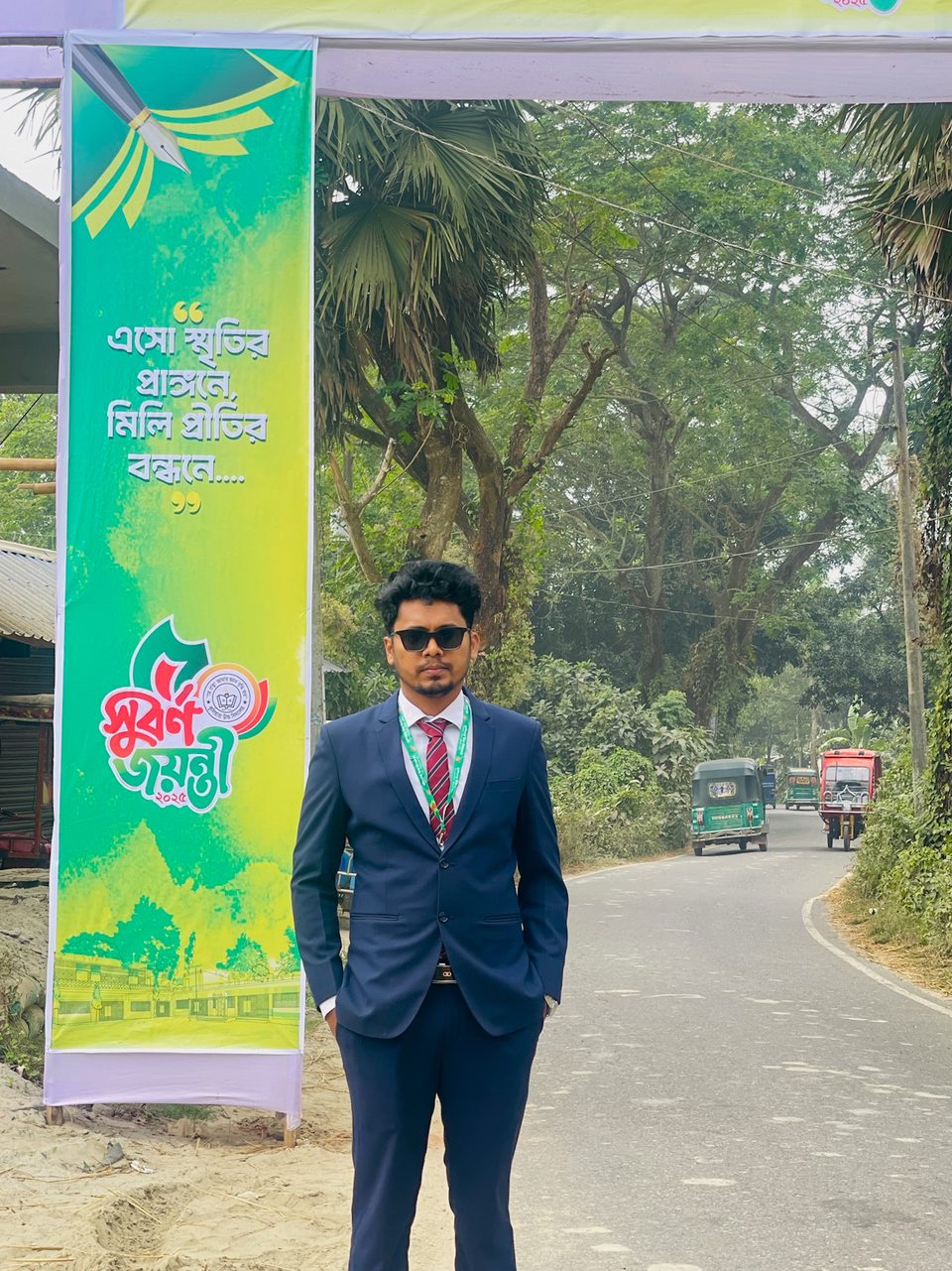 Shahriar wearing a blue jacket in an open field