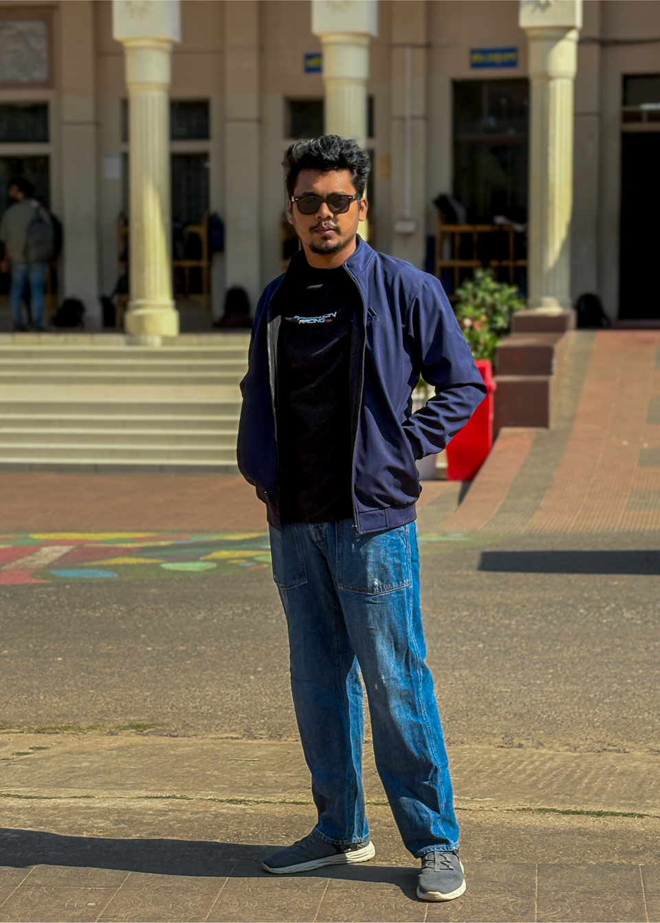 Shahriar in a casual portrait outside an institutional building